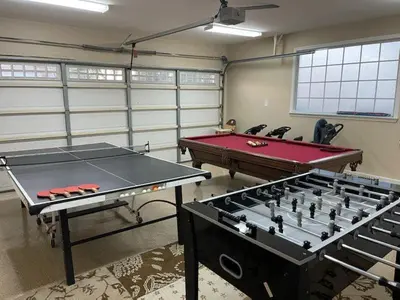 two ping pong tables sitting in a room with two tables at Destination #28 in Anaheim