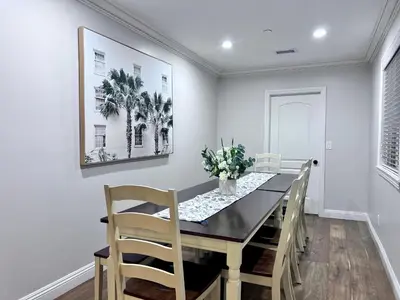 a dining room with a black table and chairs at Destination #28 in Anaheim