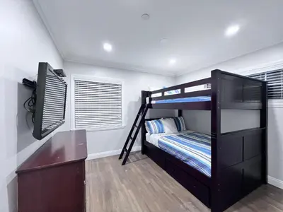 a bedroom with two bunk beds and a desk at Destination #28 in Anaheim