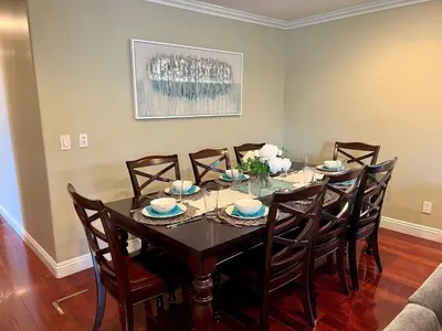 a dining room with a table and eight chairs at Destination #16 in Anaheim