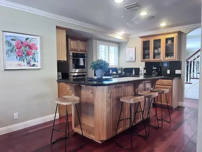 a kitchen with a island with bar stools at Destination #16 in Anaheim