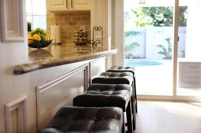 a row of bar stools in a kitchen with a counter at Destination #26 in Anaheim