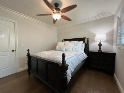 a bedroom with a bed with a ceiling fan at Destination #29 in Anaheim