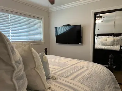 a bedroom with a bed and a flat screen tv at Destination #29 in Anaheim