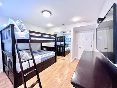 a room with two bunk beds and a staircase at Destination #36 in Anaheim