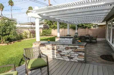 a patio with a grill and chairs on a deck at Destination #36 in Anaheim