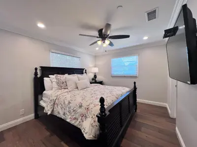 a bedroom with a bed with a ceiling fan at Destination #30 in Anaheim
