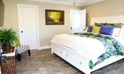 a bedroom with a large white bed with blue pillows at Destination #30 in Anaheim