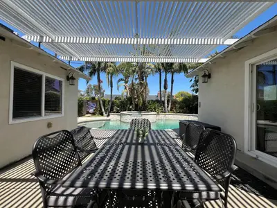 a patio with a table and chairs next to a pool at Destination #30 in Anaheim