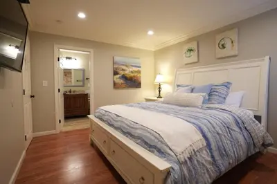 a bedroom with a large bed and a bathroom at Destination #18 in Anaheim