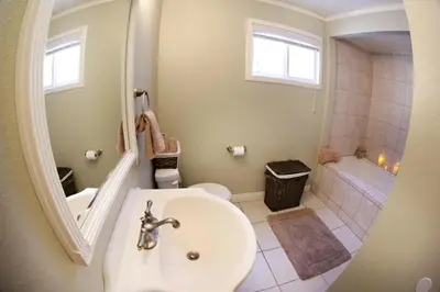 a bathroom with a sink and a toilet and a tub at Destination #18 in Anaheim