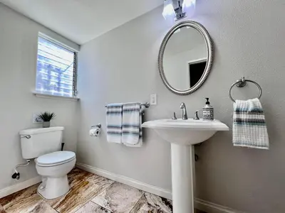 a bathroom with a toilet and a sink and a mirror at Destination #18 in Anaheim