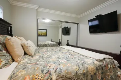 a bedroom with a bed and a flat screen tv at Destination #18 in Anaheim