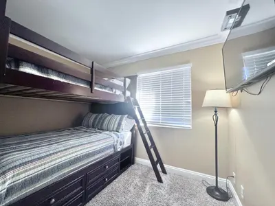 a bedroom with a bunk bed and a lamp at Destination #20 in Anaheim