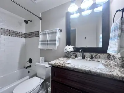 a bathroom with a sink and a toilet and a mirror at Destination #20 in Anaheim