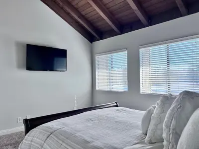 a bedroom with a bed and a flat screen tv at Destination #20 in Anaheim