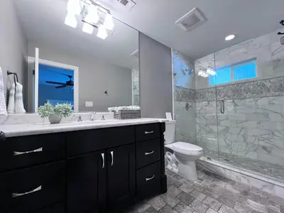 a bathroom with a sink and a toilet and a shower at Destination #33 in Orange