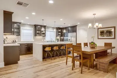 a kitchen and dining room with a wooden table and chairs at Destination #43 in Orange
