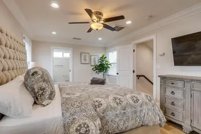 a bedroom with a bed and a ceiling fan at Destination #43 in Orange