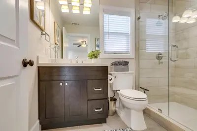 a bathroom with a toilet and a sink and a shower at Destination #43 in Orange