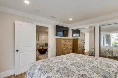 a bedroom with a large bed and a bathroom at Destination #43 in Orange