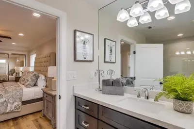 a bathroom with a sink and a large mirror at Destination #43 in Orange