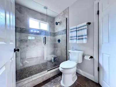 a bathroom with a toilet and a glass shower at Destination #22 in Anaheim