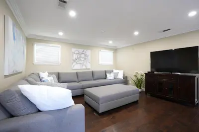 a living room with a couch and a flat screen tv at Destination #22 in Anaheim