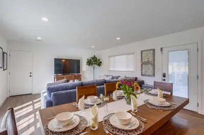 a living room with a table and a blue couch at Destination #46 in Fullerton