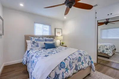 a bedroom with a bed and a ceiling fan at Destination #46 in Fullerton