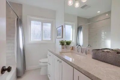 a white bathroom with a sink and a toilet at Destination #46 in Fullerton