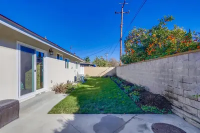 a yard next to a house with a brick wall at Destination #46 in Fullerton