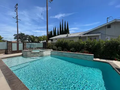 a swimming pool with blue water in a yard at Destination #46 in Fullerton