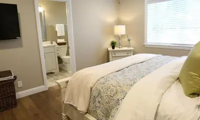 a bedroom with a bed and a bathroom with a sink at Destination #31 in Anaheim