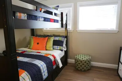 a bedroom with a bunk bed with an orange pillow at Destination #31 in Anaheim