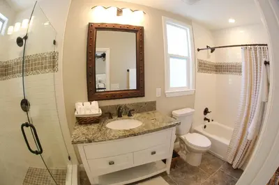 a bathroom with a sink and a toilet and a mirror at Destination #32 in Anaheim