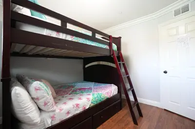a bedroom with two bunk beds with a ladder at Destination #25 in Anaheim