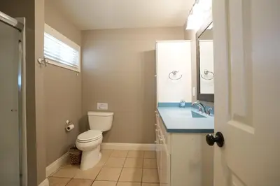 a bathroom with a toilet and a sink and a mirror at Destination #25 in Anaheim
