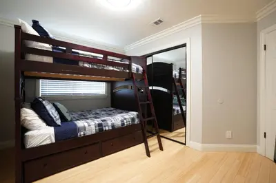 a bedroom with a bunk bed and a mirror at Destination #25 in Anaheim