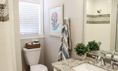 a bathroom with a toilet and a sink and a mirror at Destination #34 in Santa Ana