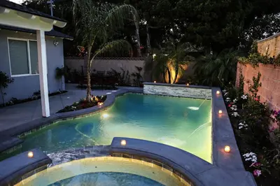 a small swimming pool in a backyard at night at Destination #35 in Anaheim