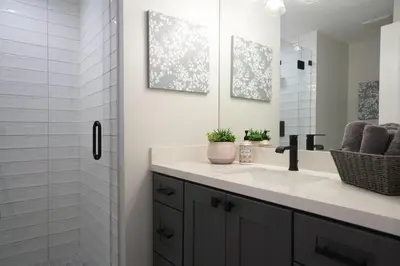 a white bathroom with a sink and a mirror at Destination #50 in Placentia