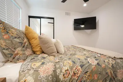 a bedroom with a couch with pillows on it at Destination #50 in Placentia