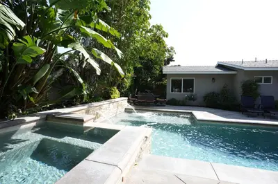 a swimming pool in a yard next to a house at Classy PoolJac Home: 2 Ensuites 34 Mile2Disney in Anaheim
