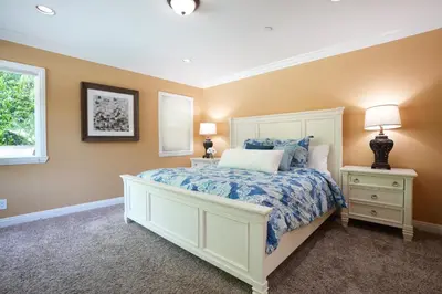 a bedroom with a bed and two lamps and a window at Classy PoolJac Home: 2 Ensuites 34 Mile2Disney in Anaheim