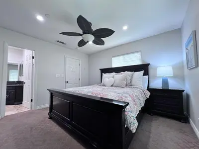 a bedroom with a bed and a ceiling fan at Destination #15 in Anaheim