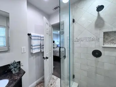 a bathroom with a shower with a glass door at Destination #15 in Anaheim