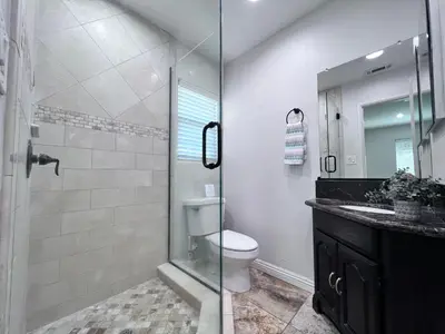 a bathroom with a shower with a toilet and a sink at Destination #15 in Anaheim