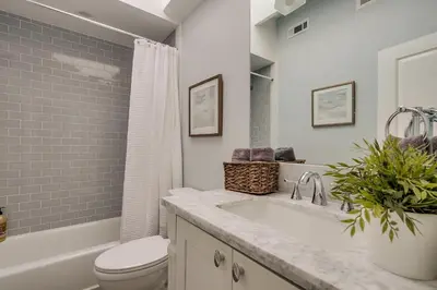 a bathroom with a sink and a toilet and a tub at Destination #41 in Fullerton