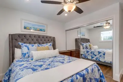 a bedroom with a bed and a ceiling fan at Destination #44 in Orange